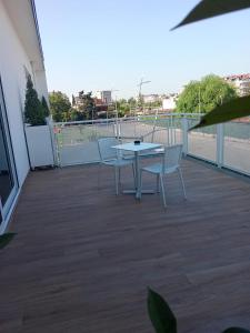 a patio with a table and two chairs on a balcony at the roof hotel in Caserta