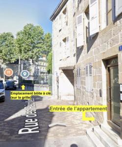 a building with a sign on the side of a street at Appartement T2 hyper centre in Brive-la-Gaillarde