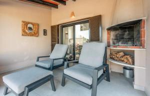 two chairs sitting in a room with a fireplace at Casa Soleada in Capdepera