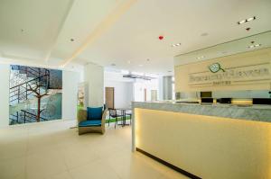 a lobby of a hotel with a counter and a bar at Boracay Haven Suites in Boracay +37 photos