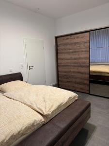 a bedroom with a large bed and a large closet at Ferienwohnung Alina in Werne an der Lippe