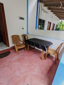 a room with a table and chairs in a room at Oceanic White House in Nilaveli