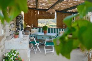 a patio with a blue table and chairs on it at Borda de Fadrín in Ipiés