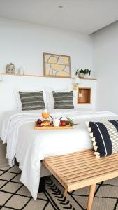 a white bed with a tray of fruit on it at Villa Sunset St Gilles in Saint-Paul