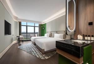 a bedroom with a bed and a sink and a mirror at Wingate by Wyndham Xi'an Chanba in Xi'an +38 photos