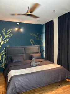a bedroom with a bed with a ceiling fan at Crown plaza hotel and cafe in Kasol