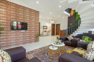 a living room with a brick wall at Badakshan Bliss in Srinagar