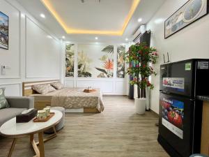a living room with a bed and a tv at Baodang-Homestay in Hanoi