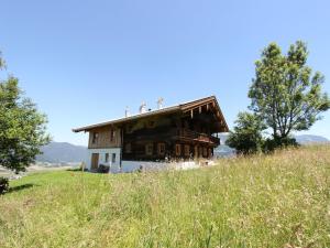 an old barn on a hill in a field at Chalet in St Johann by Ski Slope in Sankt Johann in Tirol