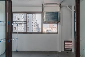 a room with a window with a view of a city at srivaramansion 1 by cream in Ban Na Song