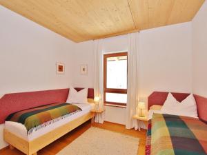 a bedroom with two beds and a window at Chalet in St Johann by Ski Slope in Sankt Johann in Tirol