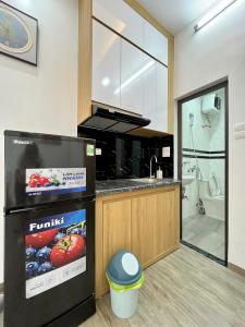 a kitchen with a black refrigerator and a sink at Baodang-Homestay in Hanoi +7 photos