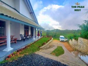 a porch of a house with a car parked outside at The Peak Nest in Nuwara Eliya