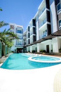 a large swimming pool in front of a building at Boracay Haven Suites in Boracay