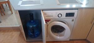 a washer and dryer under a counter in a kitchen at Уютная 1 комнатная квартира на Сейфуллина 21 in Balqash