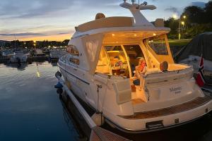 a boat is docked in a marina at sunset at Frognerstranda - Majestic- in Oslo +10 photos