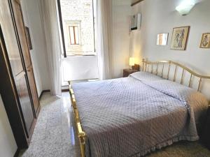 a bedroom with a bed and a window at Dimora dei Consoli in Gubbio +19 photos