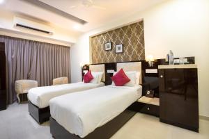 a hotel room with two beds in a room at Hotel Laaiba Residency in Mumbai