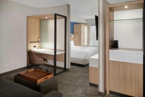 a hotel room with a bed and a mirror at SpringHill Suites by Marriott Lansing West in Lansing +24 photos