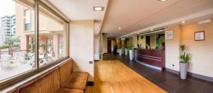 a hallway of a building with a cafeteria at Hotel Residence Ulivi E Palme in Cagliari