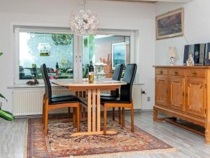 a dining room with a wooden table and chairs at 2 person holiday home in Gråsten in Gråsten +30 photos