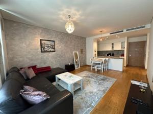 a living room with a couch and a table at Queen Apartments Belgrade Waterfront in Belgrade