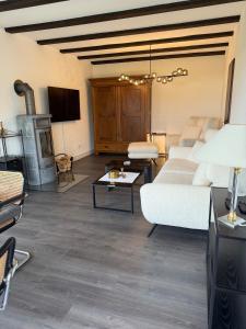 a living room with a white couch and a fireplace at Lieblingsort Susanna in Wenkbach