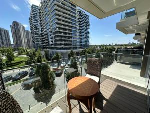 a balcony with a table and chairs on a balcony at Queen Apartments Belgrade Waterfront in Belgrade