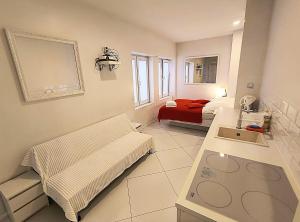 a hospital room with a bed and a sink at Mirror Apartments in Kraków