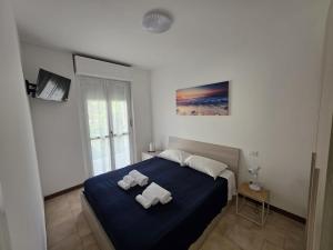 a bedroom with a bed with two towels on it at Appartamento Brixia in Brescia
