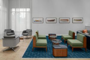 a waiting room with chairs and chairs in a waiting room at Courtyard Fort Lauderdale East Lauderdale-by-the-Sea in Fort Lauderdale