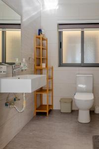 a bathroom with a sink and a toilet at Luqa 3 bedroom penthouse T in Luqa +9 photos