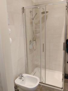 a bathroom with a shower and a toilet and a sink at da Paola monolocale in Osoppo