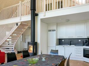 a kitchen and dining room with a table and a fireplace at Cozy Retreat in Unnaryd Oasis-By Traum in Unnaryd +19 photos