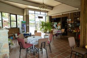 a restaurant with a table and chairs in a room at Ken's House Dalat in Da Lat