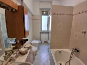 a bathroom with a tub and a toilet and a sink at Central Art House in Como +30 photos