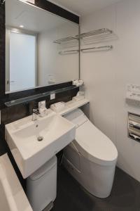 a bathroom with a sink and a toilet and a mirror at 喜々Kiki in Miyazu