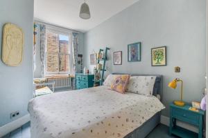 a bedroom with a bed and a window at Charming London with balcony in London