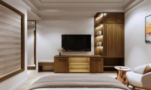a bedroom with a bed and a flat screen tv at Royal Hotel in Móng Cái