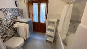 a bathroom with a toilet and a sink and a shower at Casa Lu' in Rocca Pia