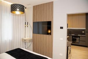 a bedroom with a bed and a tv on a wall at The Three Diamonds - B&B CESENATICO in Cesenatico