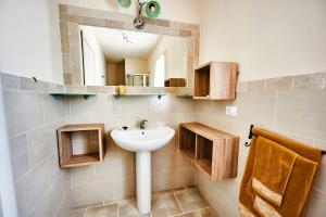 a bathroom with a sink and a mirror at Trullo Felice winter in Ostuni +17 photos