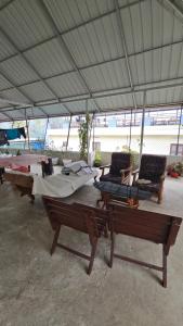 two tables and chairs under a large tent at ThekkadyPknhomes in Thekkady