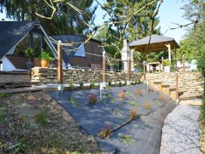 a garden with potted plants in front of a cabin at Chalet in Gesves with Roof Terrace, Garden, BBQ in Gesves