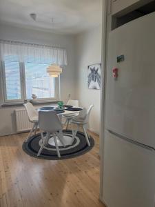 a kitchen with a table and chairs and a refrigerator at Comfortable two-room apartment in the city center in Kemi