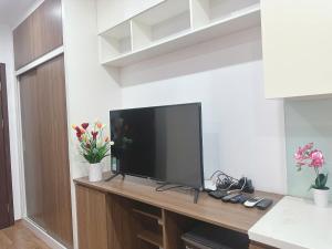 a flat screen tv sitting on top of a wooden table at Trăng Khuyết 404MD in Hanoi