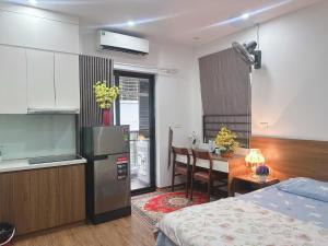 a kitchen and a room with a bed and a table at Trăng Khuyết 404MD in Hanoi