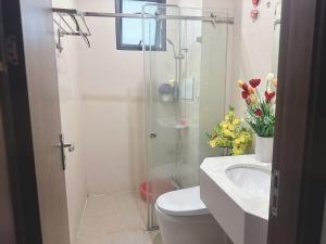 a bathroom with a shower and a toilet and a sink at Trăng Khuyết 404MD in Hanoi +30 photos