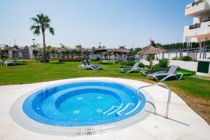 a swimming pool in the middle of a yard at Modern 2BR Apt with own Terrace & Pool access in Pulpí