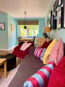 a living room with a couch and a table at Lovely 2 bedroom house in Bath with private parking garden WiFi & easy access to city centre in Bath